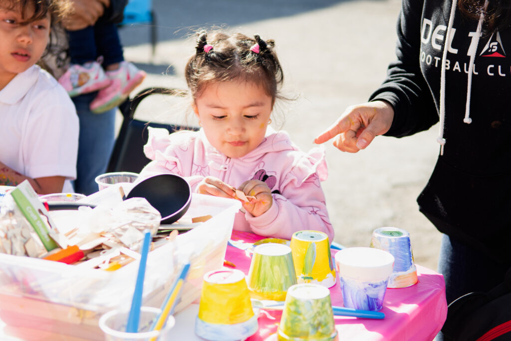 Young girl playing with art supplies outside
