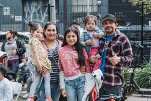 A family stands together at a community event